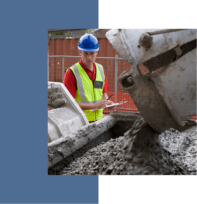 Construction worker pouring concrete at a building site.